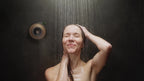 Person using ScentXpresso smart shower diffuser