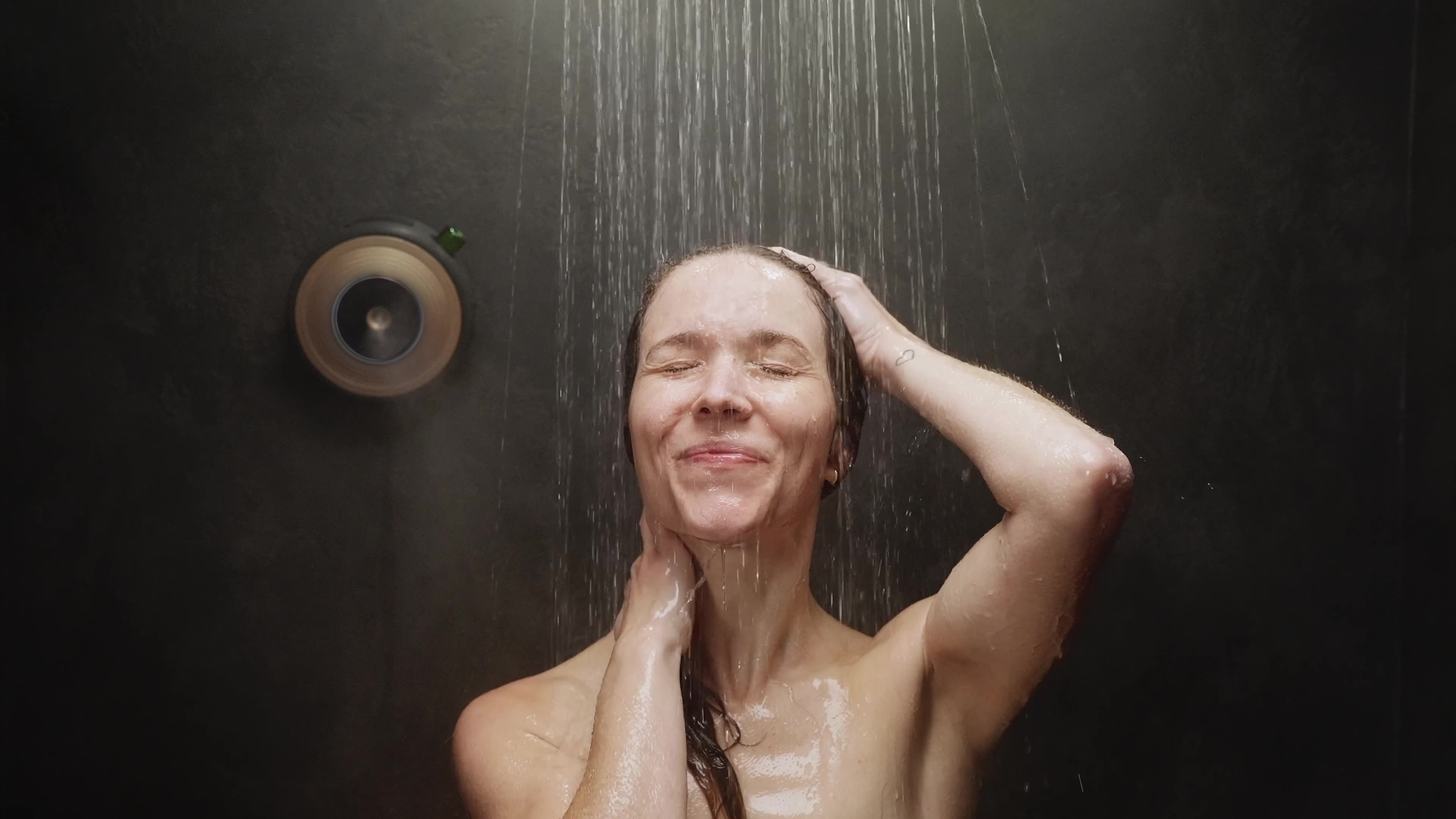 Person using ScentXpresso smart shower diffuser